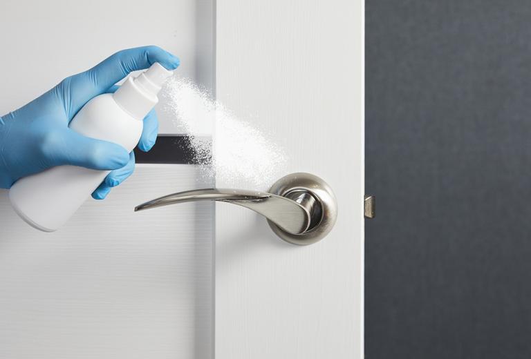 door handle sprayed with disinfectant